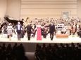 The composers, the singer and the conductor saluting the public